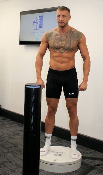 A customer standing ready for a 3d body scan